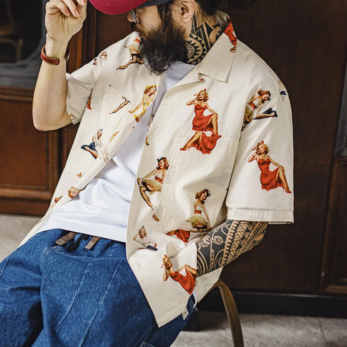 Person wearing a jacket with vintage-style pin-up girl designs in a casual setting.